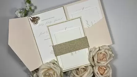 Blush pocket fold wedding invitation with gold accents, belly band and layers.