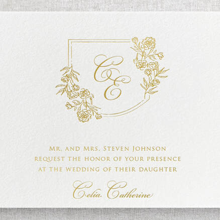 Gold foil wording on invitation featuring gold foil crest with initials.
