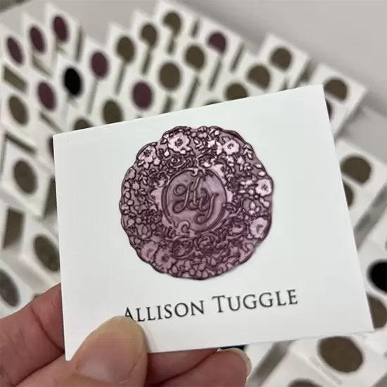 Katy's custom wax seal place card with guest name and each color indicating an entree selection.