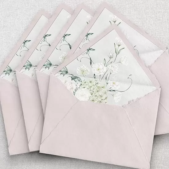 Light pink handmade envelope with hydrangea and white floral envelope liner.