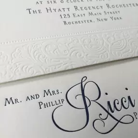 Embossed scroll and navy blue letterpress wedding invitation suite. 